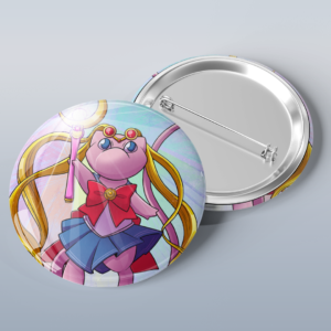 Photo of a button with art of the Pokémon Mew dress as a sailor scout from Sailor Moon.